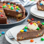 Discover the ultimate no-bake M&M's Pie recipe! Rich chocolate, creamy peanut butter, and a crisp Oreo crust make this dessert irresistible.